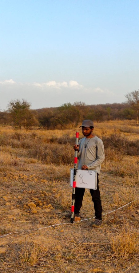 Kathan taking measurements in the field